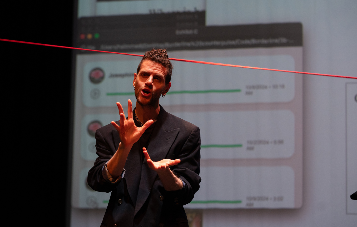 Performer moving across the stage during the border interrogation scene