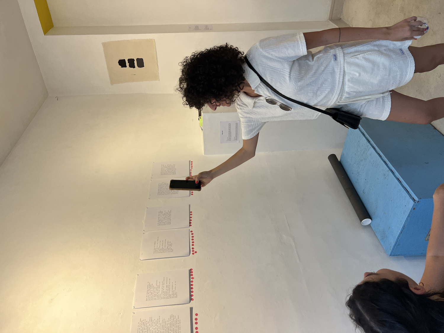 Detail of pink carnation dots accumulating on a poem page