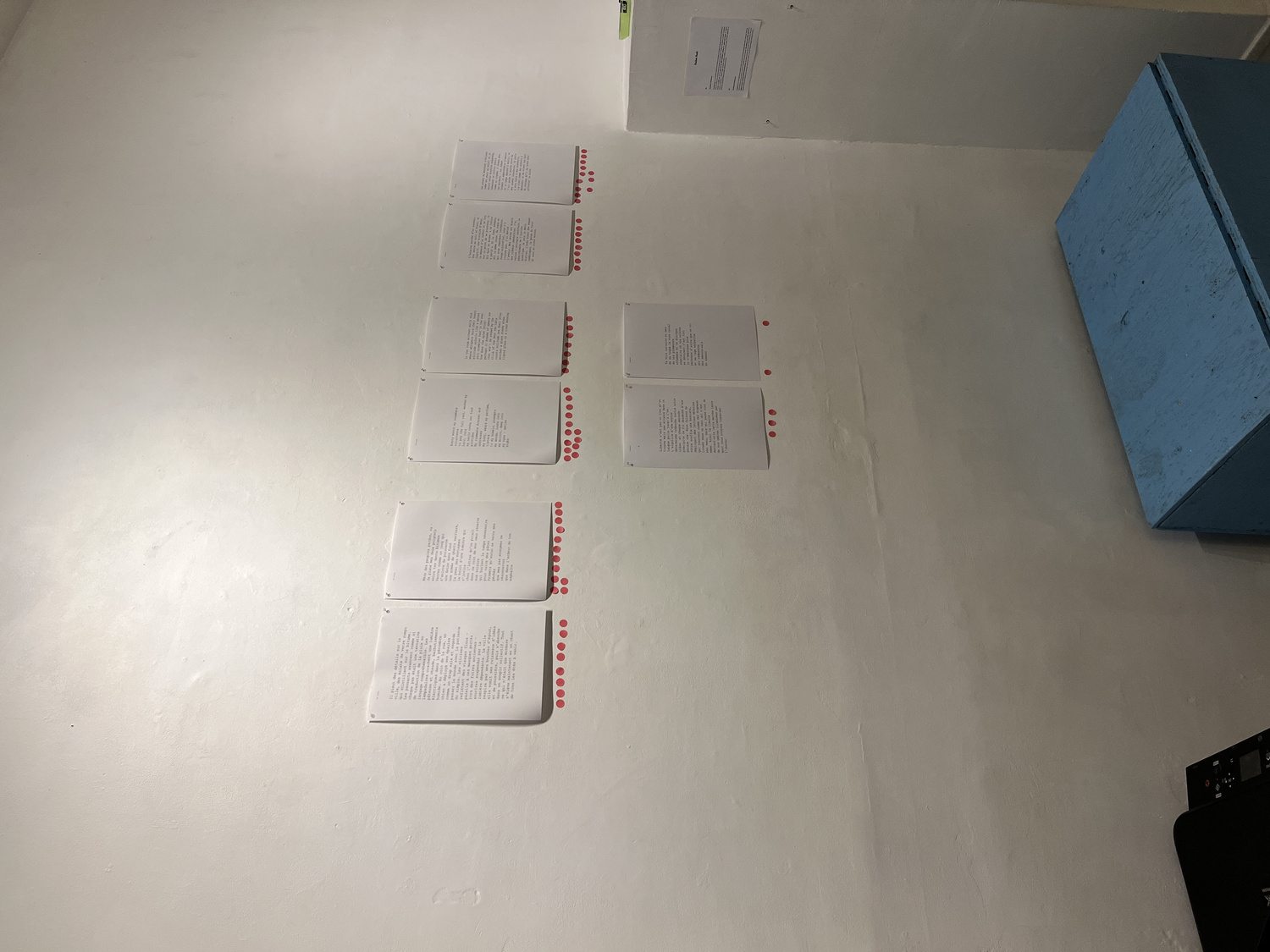 Close-up of typed poem text with carnation sticker votes