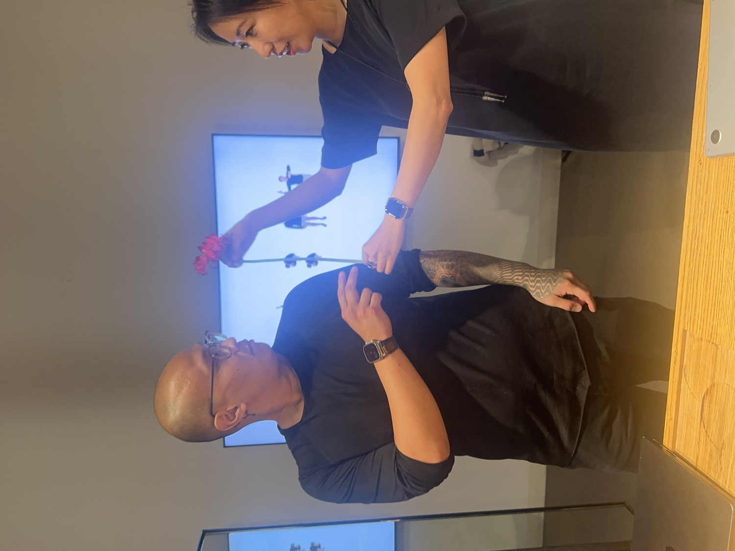 Group of audience members gathered around the table reading and voting