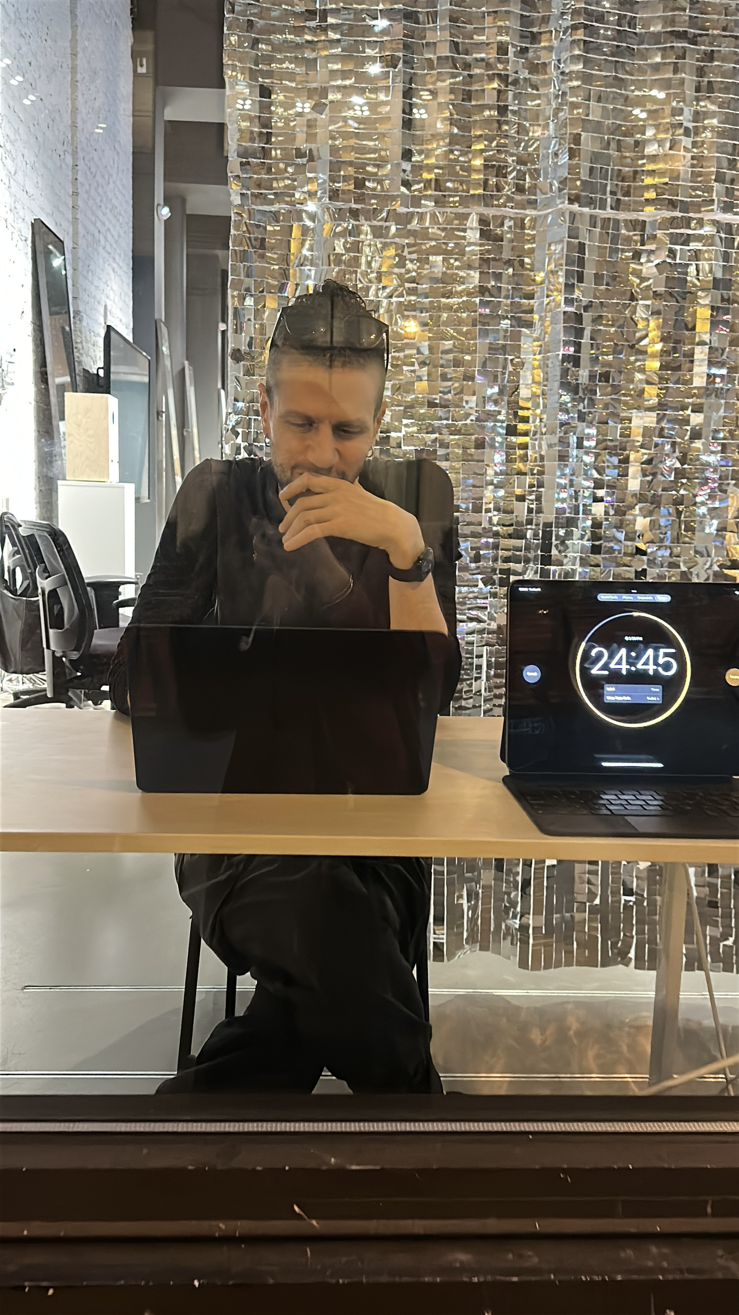 Visitor reading poem printouts at the Versus.exe voting table