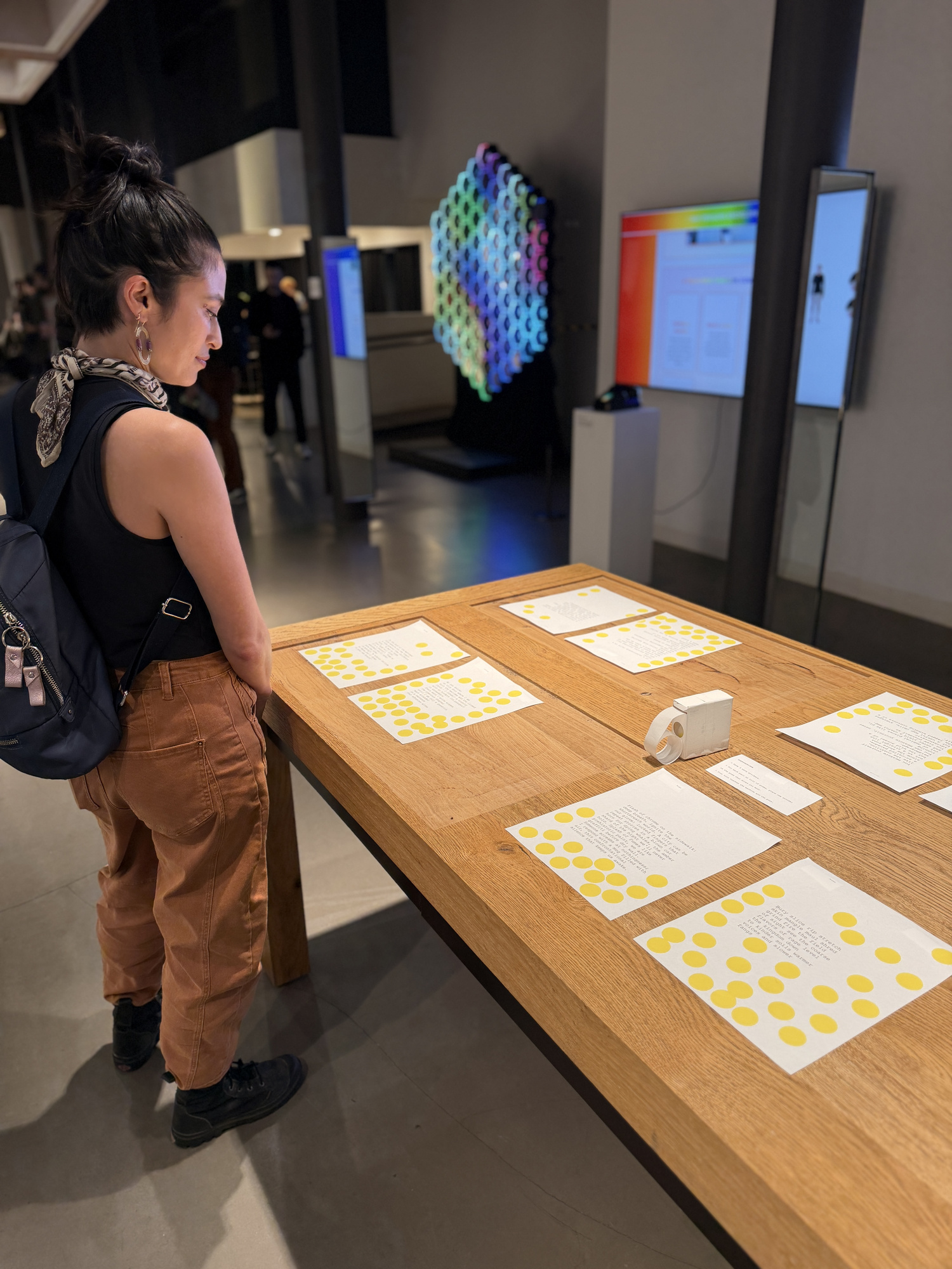 Overview of the gallery space with poems displayed on a long table